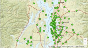 Map of western Washington state showing clusters of green dots, indicating data points or locations, concentrated around the Puget Sound region.