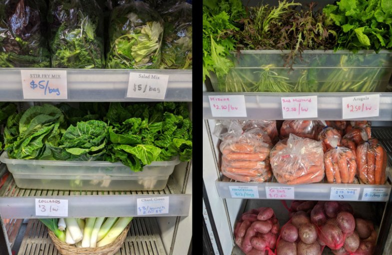 Refrigerated display of fresh vegetables for sale, including bagged salad mixes, leafy greens, carrots, green onions, and potatoes, each labeled with handwritten prices.