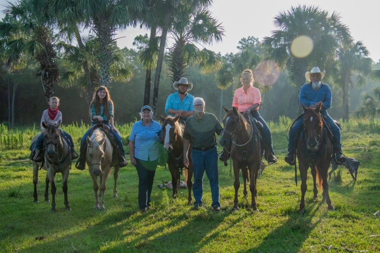Liesa and Russell Priddy with family and horses.