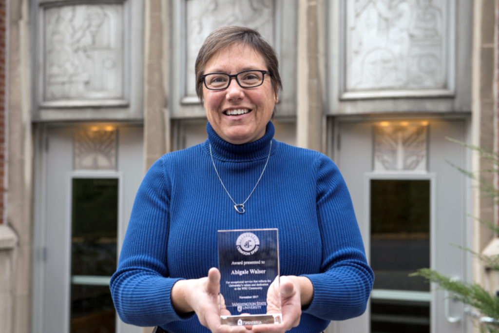 Abigale Walser in profile holding her award.