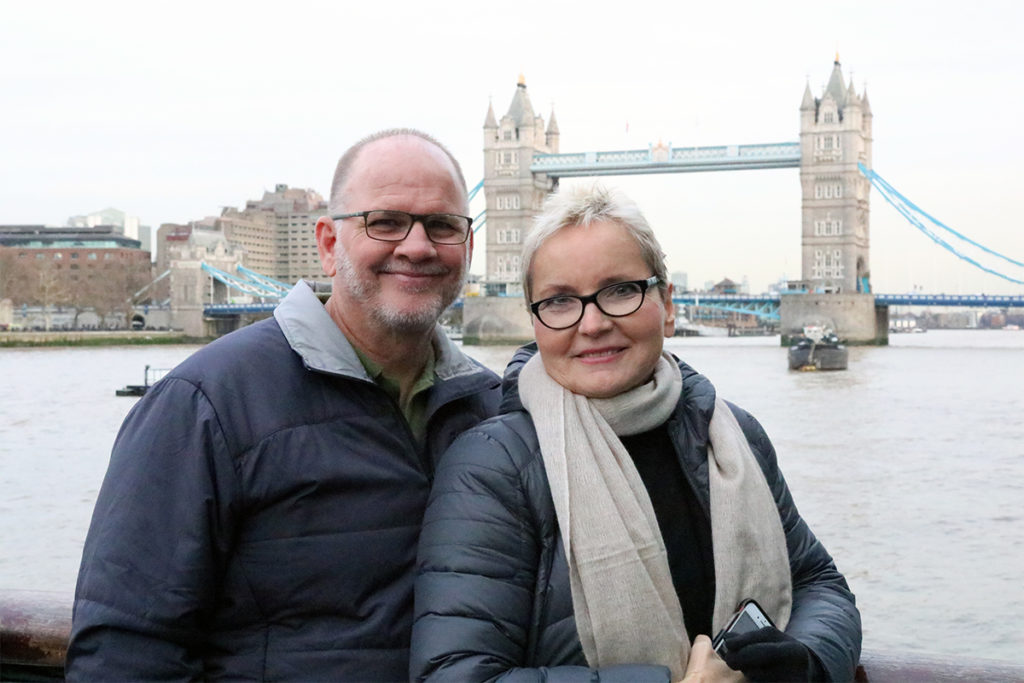 Larry Anderson and Sasha Vukelja standing water front with the London Bridge in the background