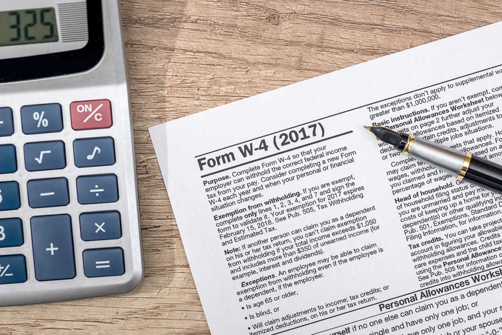 W-4 tax form with pen on desk