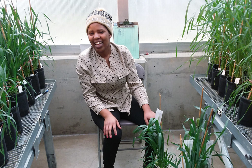 Esther Rugoli seated among plants