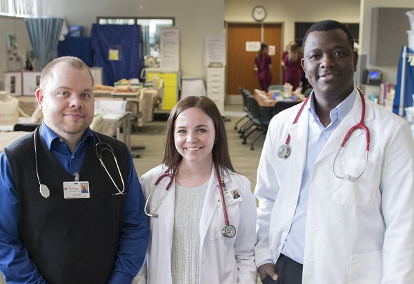 Nursing students standing in profile.