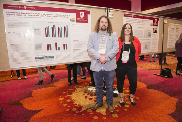 Nick Goodwin and Latoyia Butler standing in front of research posters