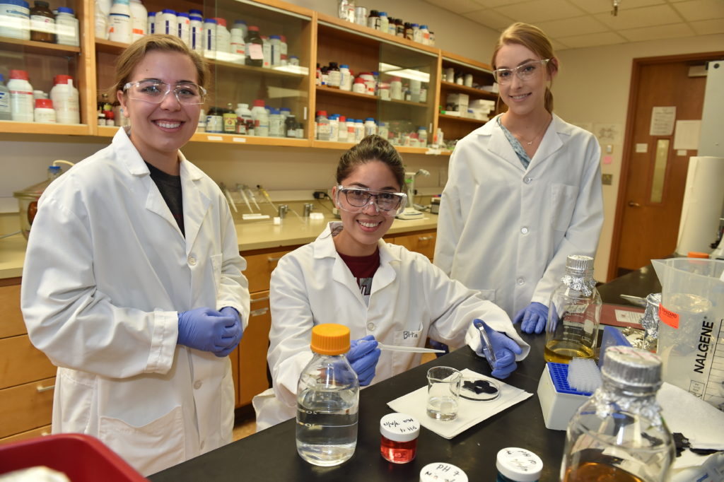Schweitzer Scholar Raquel Murillo flanked by lab partners at WSU Pullman.