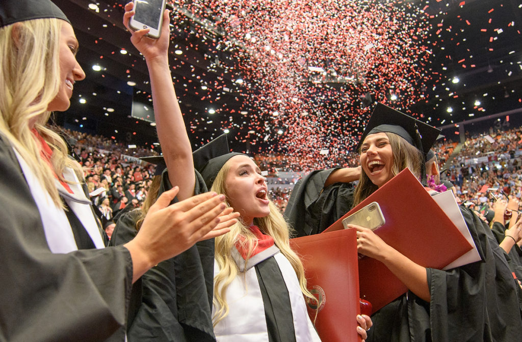 WSU graduates celebrate as confetti falls.