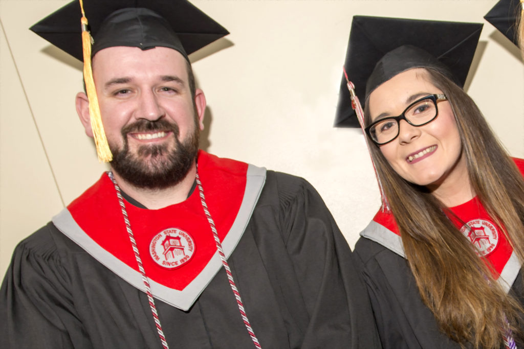 Jacob Turner and Allesondra Straggi posing in graduation robes.