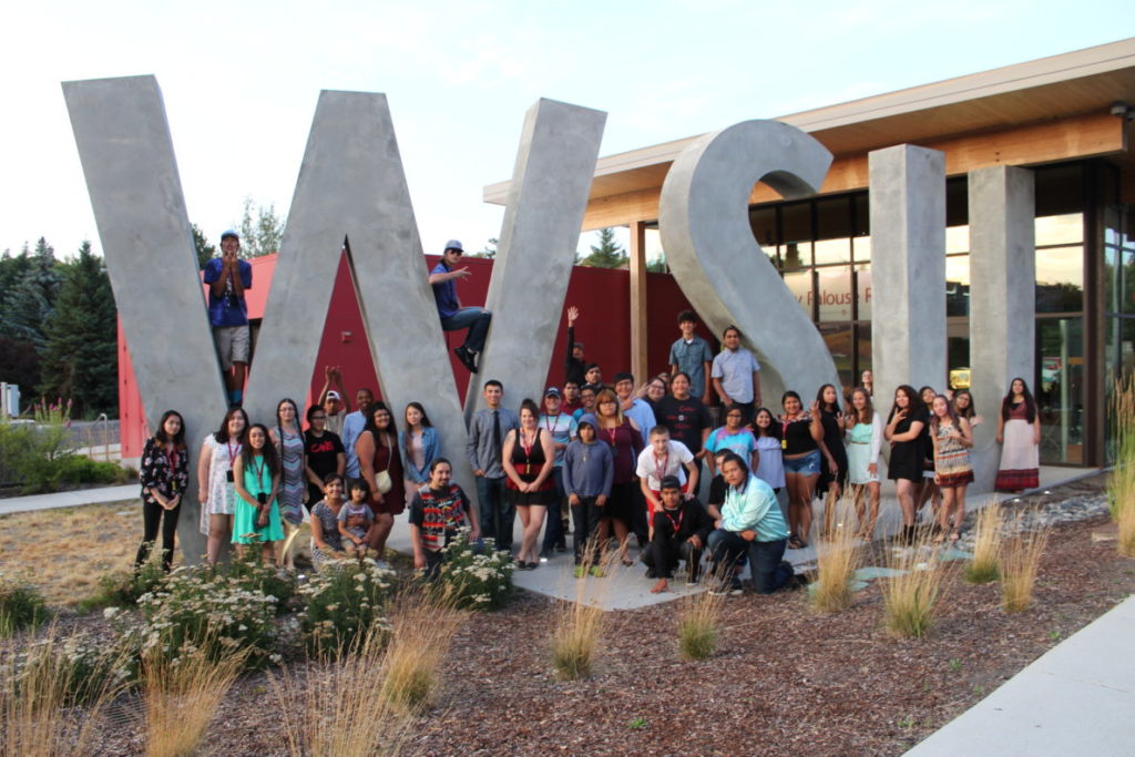 Group photo of Native peoples around the WSU visitor center