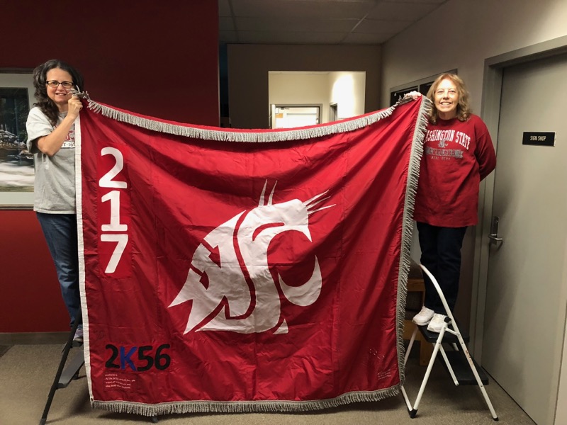 Sharon Macy and Catherine Jasmer hold the Ol' Crimson flag.