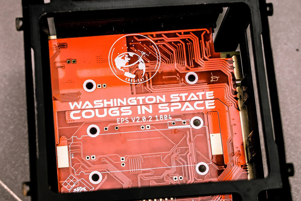Closeup of electrical circuit board labeled 'Washington State Cougs in Space'.