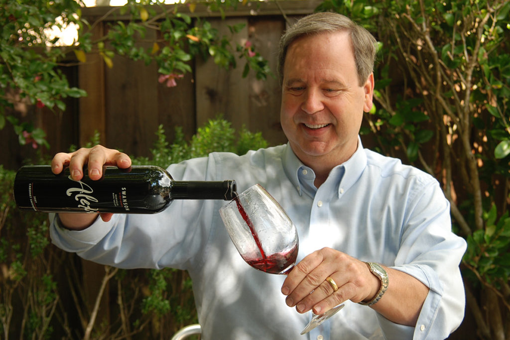 Hanni pouring a glass of red wine.