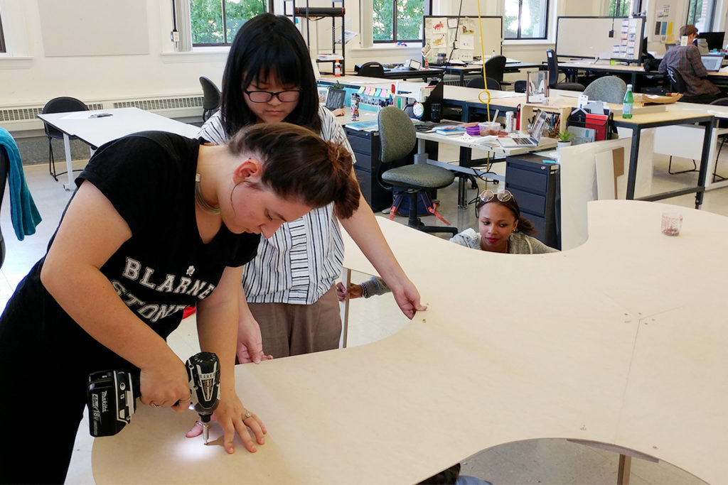 Rosenthal and Kha creating an asterisk-shaped table.