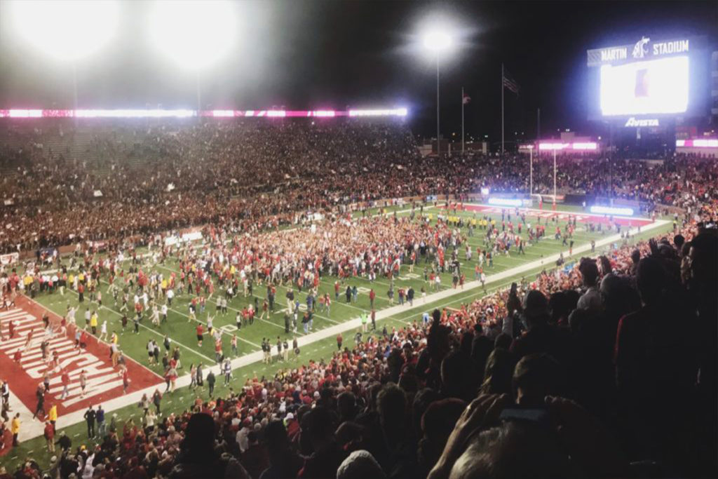 Fans gathering on the field at Martin Stadium