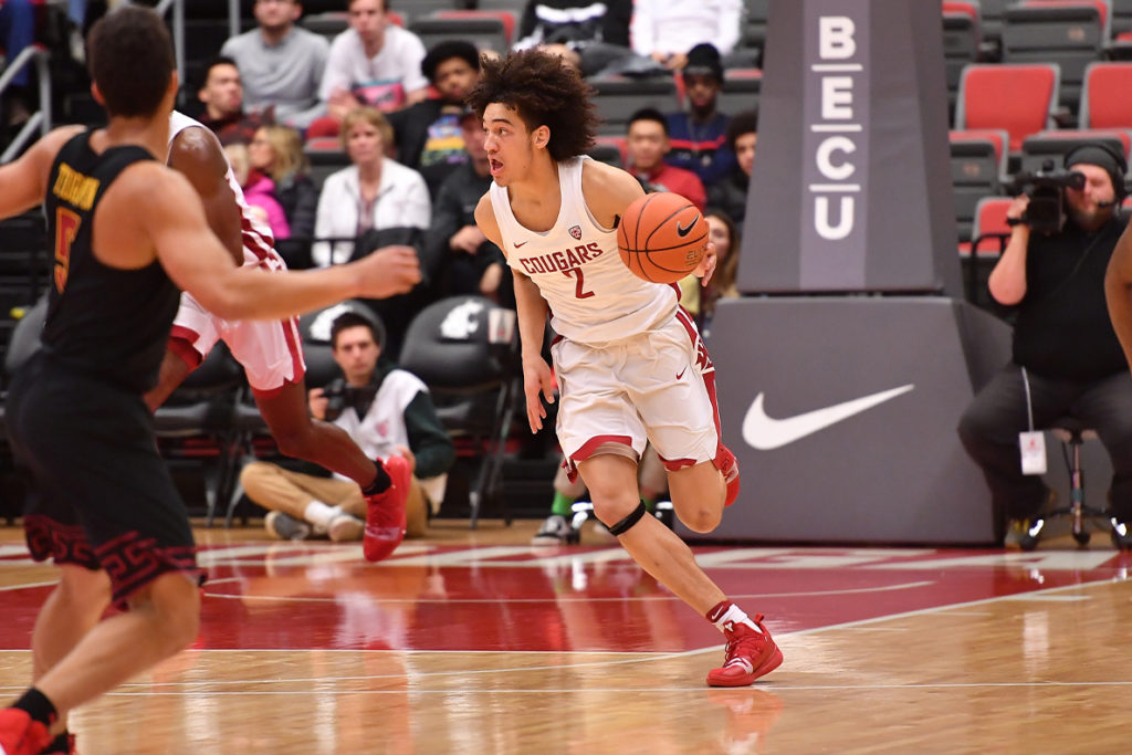 Cougars basketball player C.J. Elleby dribbles the ball during a game.
