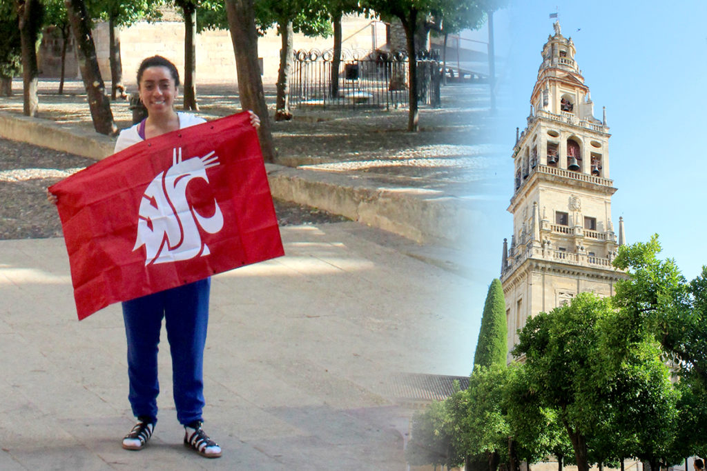 Alejandra Carranza standing with a WSU flag while traveling overseas.