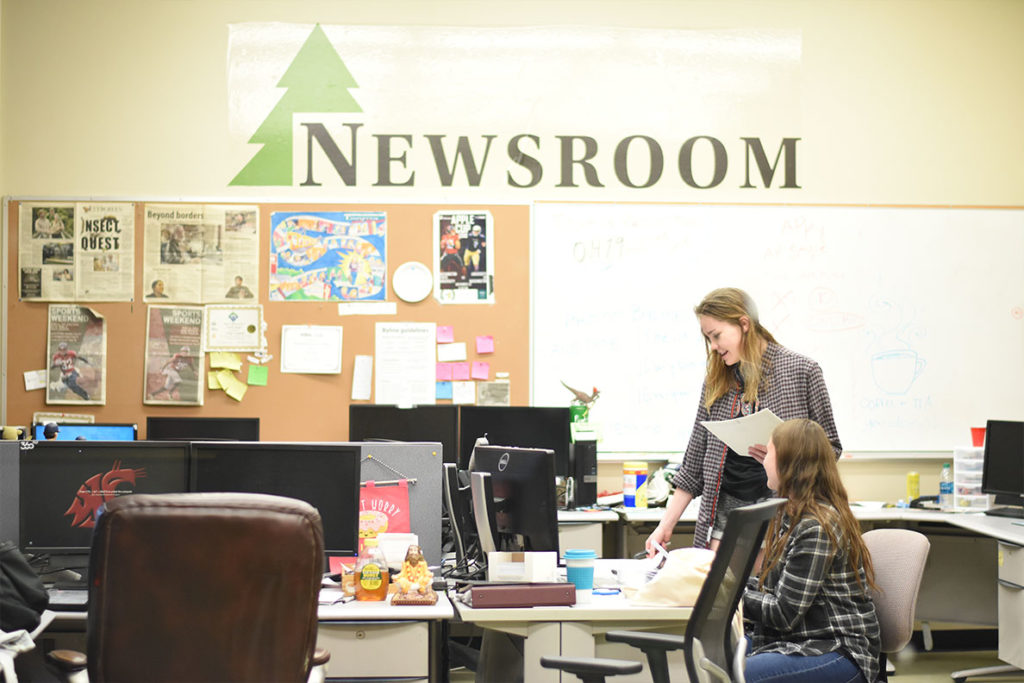 Students working in "The Daily Evergreen" newsroom.