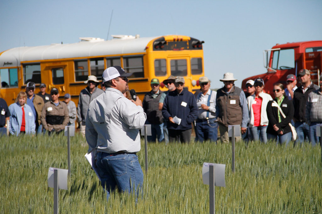 A man speaking to participants at the 2018 Lind Field Day.