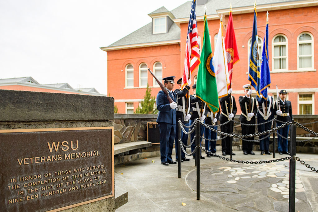 Soldiers holding flags during ceremony at WSU Veterans Memorial.