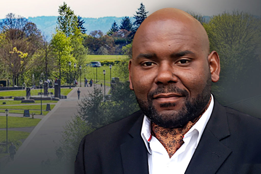 Closeup of Domanic Thomas with WSU Vancouver campus in background.