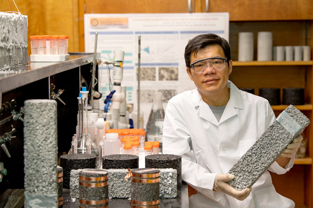 Xianming Shi in lab with pavement samples.
