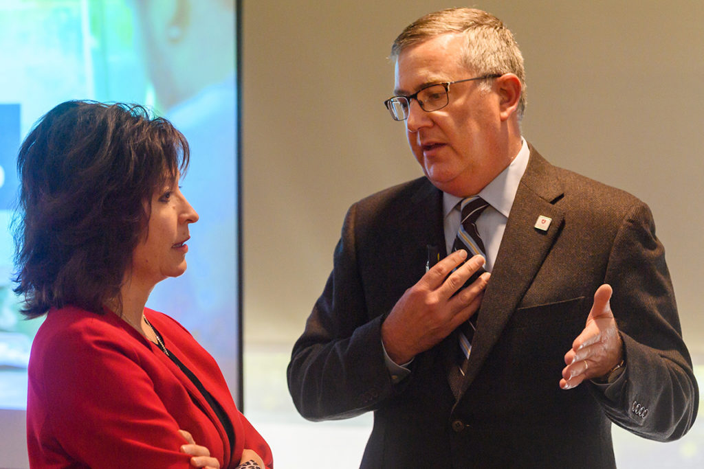 Closeup of Kirk Schulz and Mitzi Montoya talking to one another.