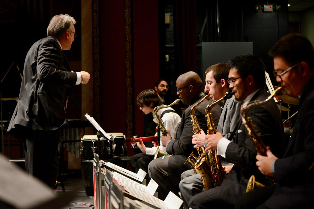 A conductor leads a jazz band.