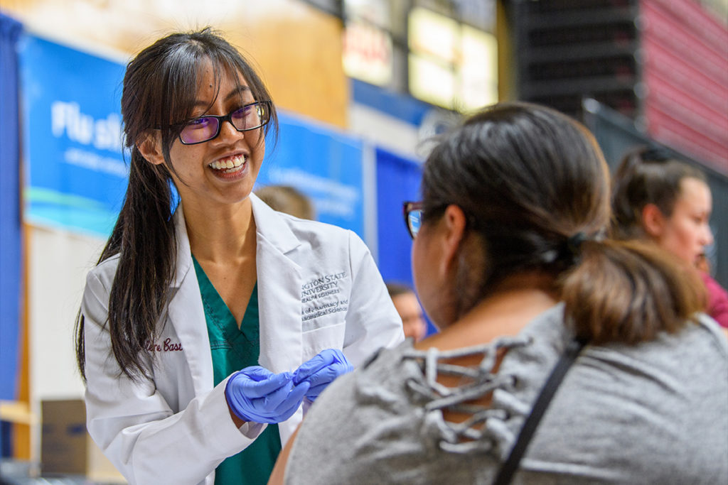 A student pharmacist gives an immunization.
