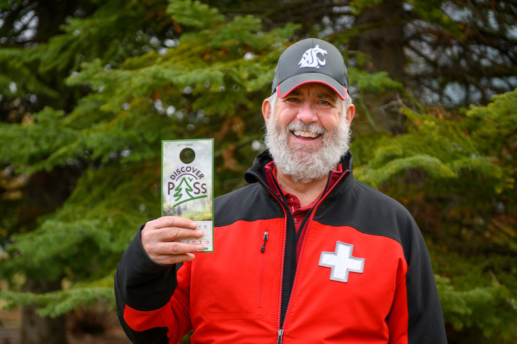 Daniel Baker holding a Discover Pass