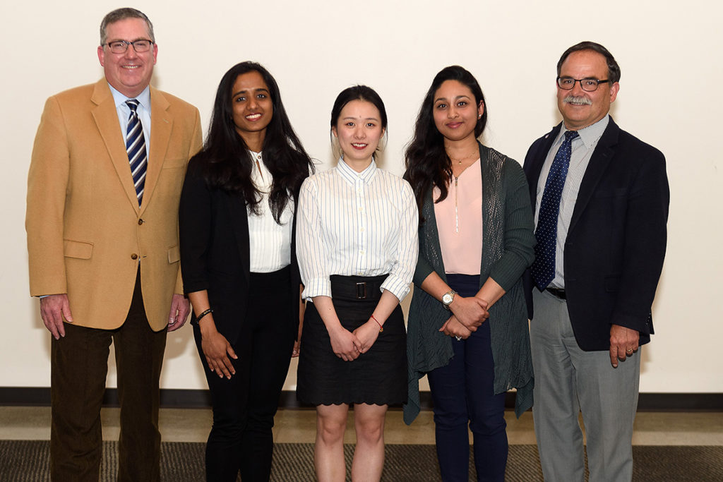 Last year's 3MT winner, Sheena Dong, center, stands with other 3MT contestants, WSU President Kirk Schulz.