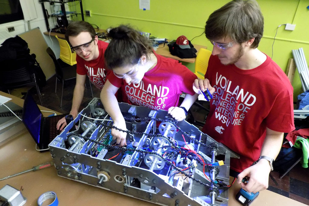 Crimson Robotics team members work on a prototype robot.