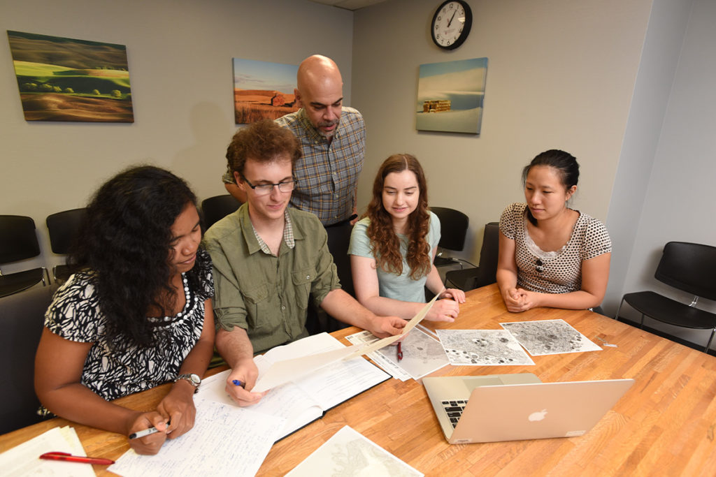 Members of the Nicola Laboratory (left to right) Tri Komala Sari, Seth Schneider, Anthony Nicola, Katrina Gianopulos and Becky Lee review data outside of the lab.