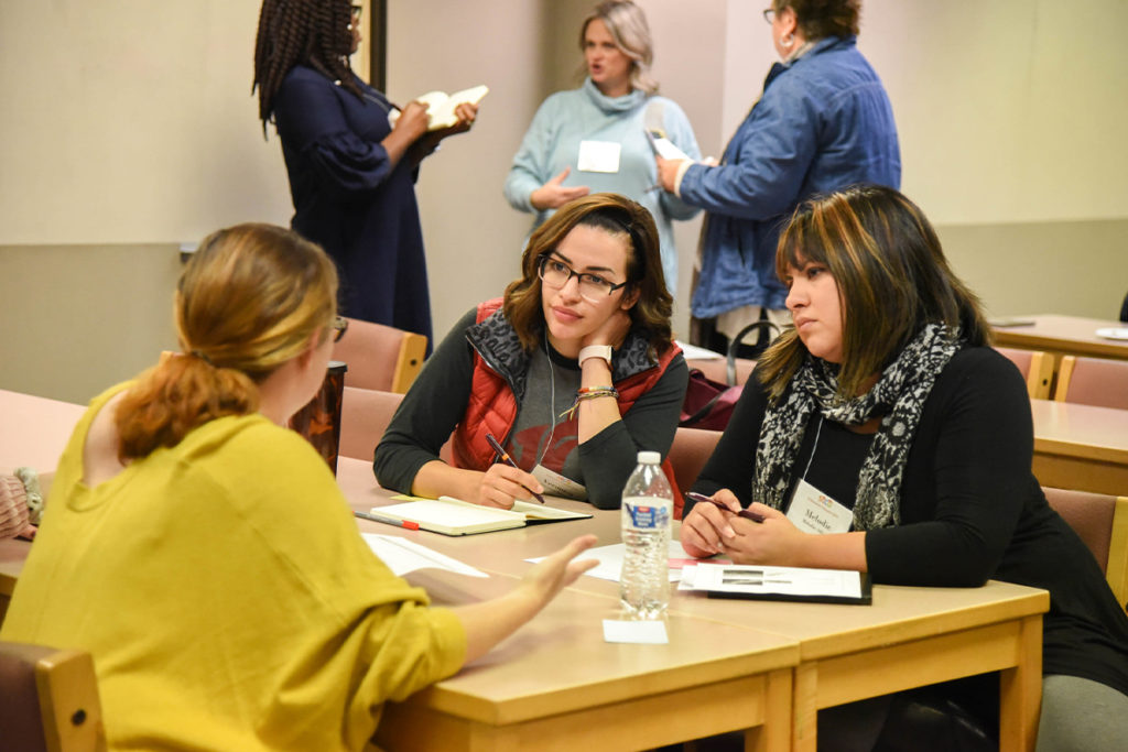 Veronica Romero (center) talks with colleagues at the WSU Tri-Cities Education Summit.