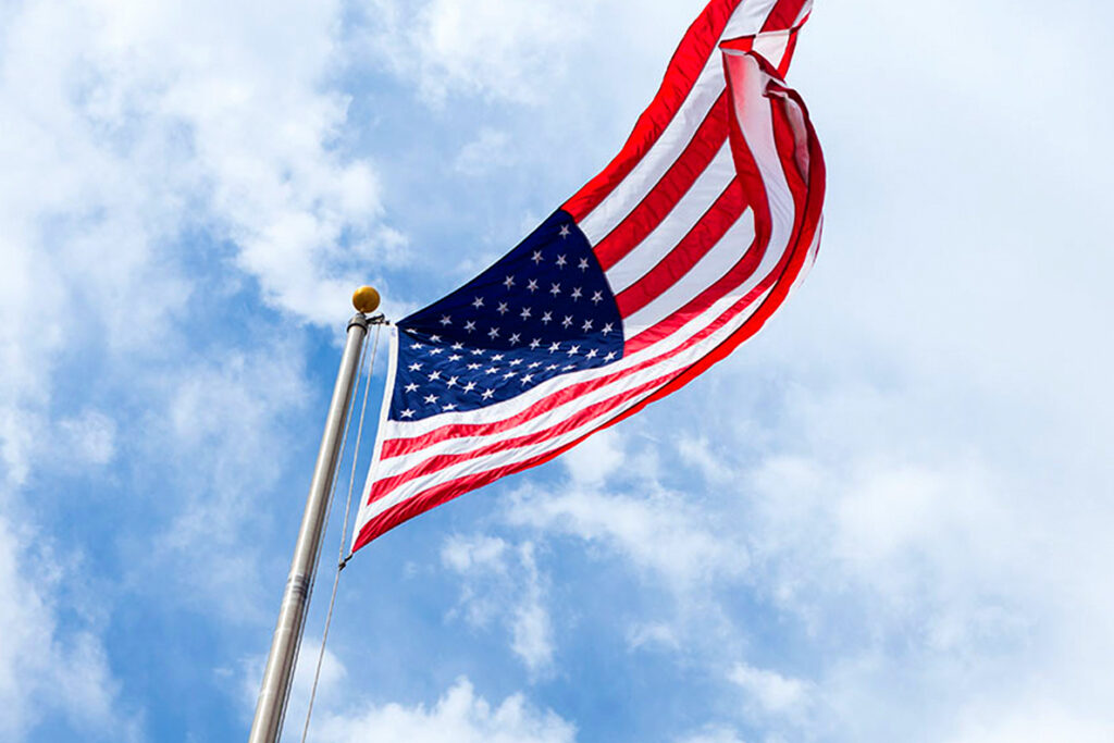 An American flag flying high in the air.