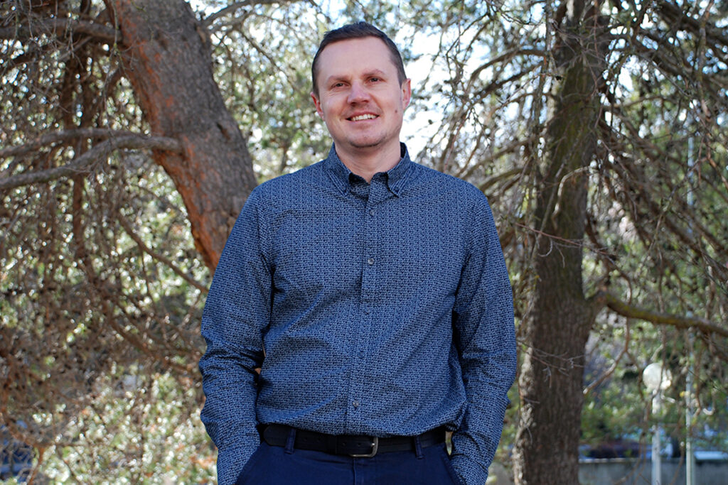 Closeup of Lapin standing in front of trees.
