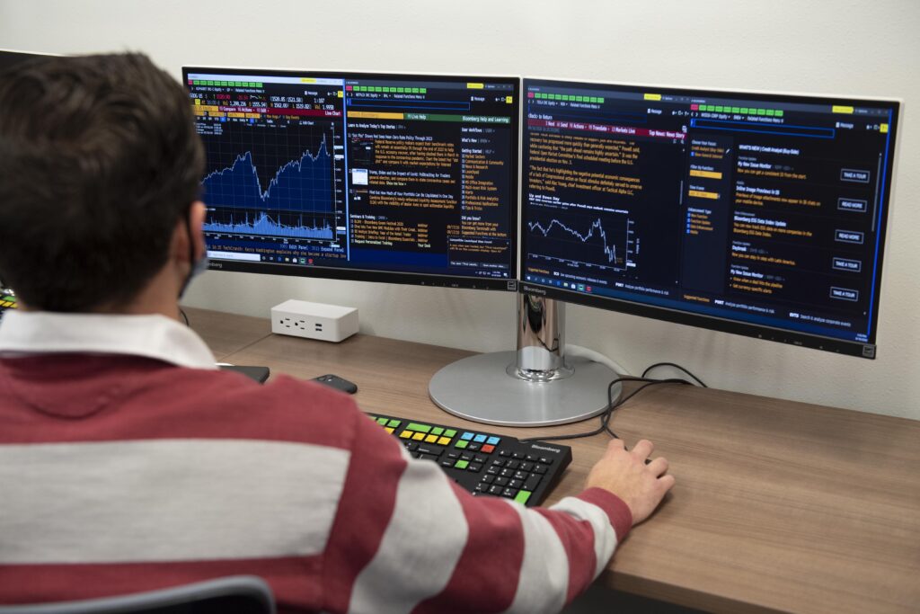 A student looks at stock reports on a computer.