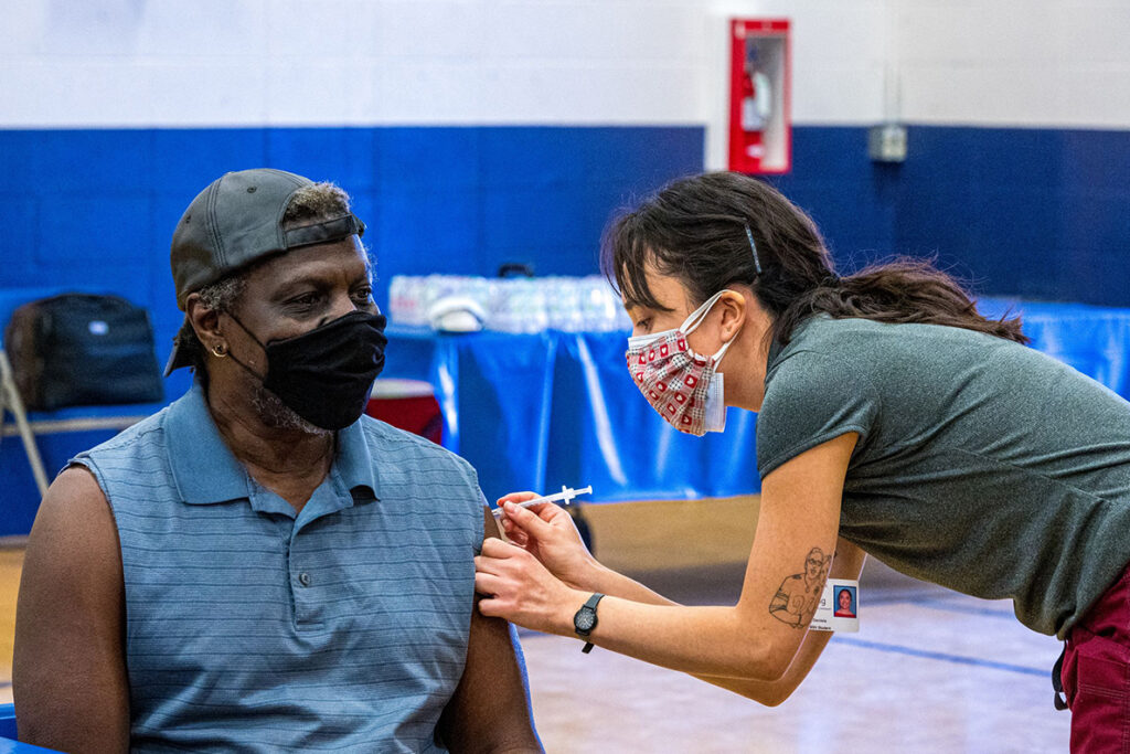 A College of Nursing student administers a COVID vaccine.