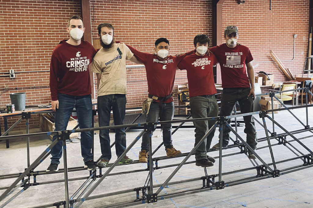 WSU students stay on a steel bridge they created for a competition
