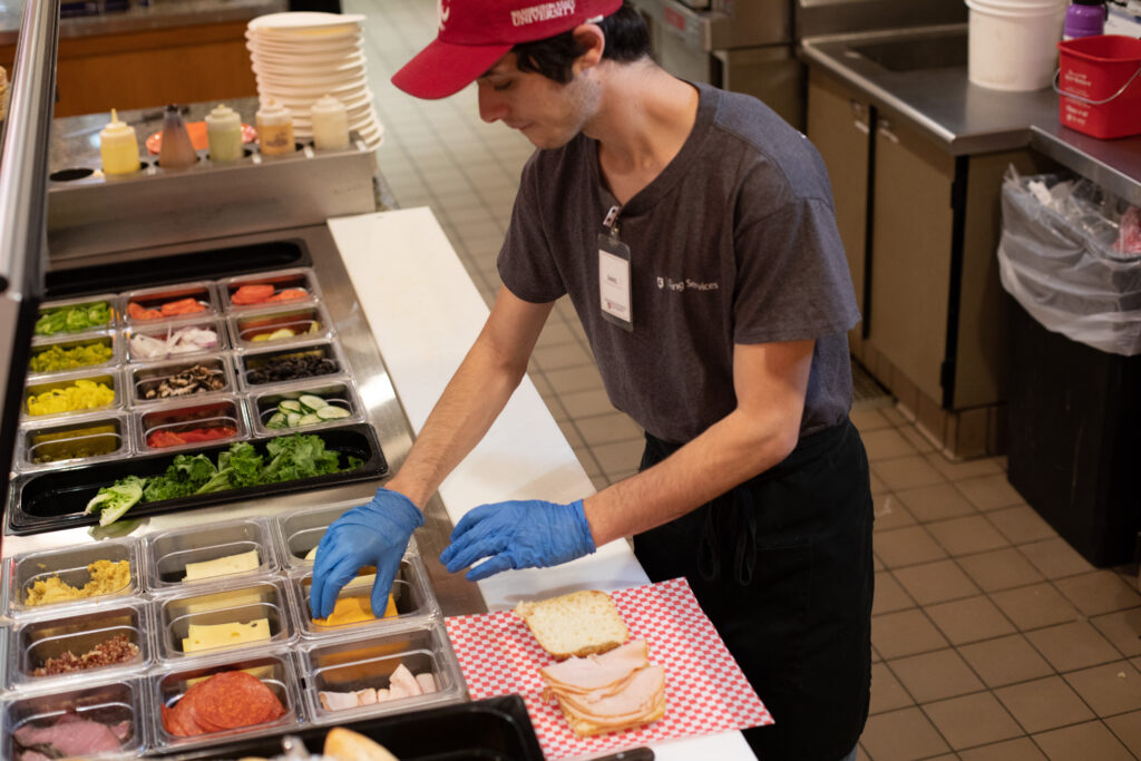 An employee prepares food at one of WSU's dining areas.