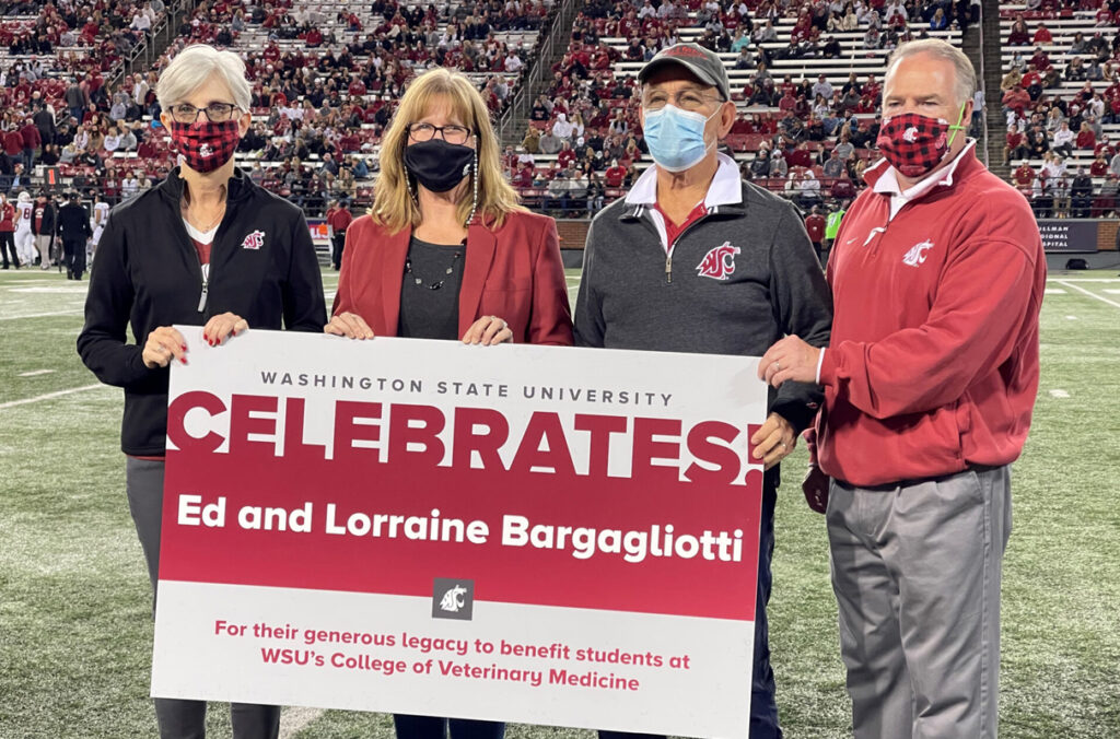 Four people holding a sign celebrating Ed and Lorraine Bargagliotti's gift to the WSU College of Veterinary Medicine.