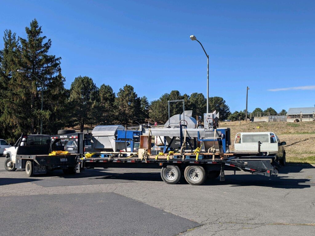 A honey extractor rests on a trailer.