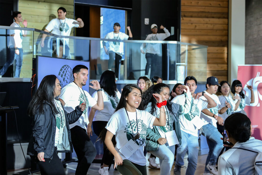 Students at the 2019 SHAPING Conference dancing in unison.