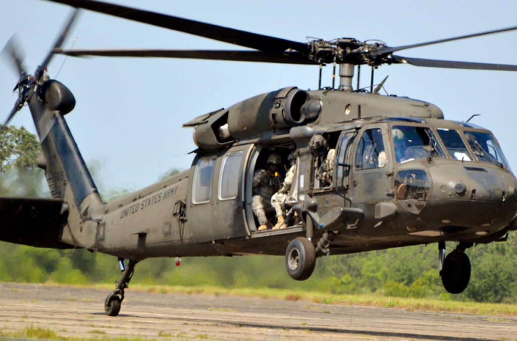 A Sikorsky UH-60 Blackhawk operated by the Army Rangers lands on a runway.