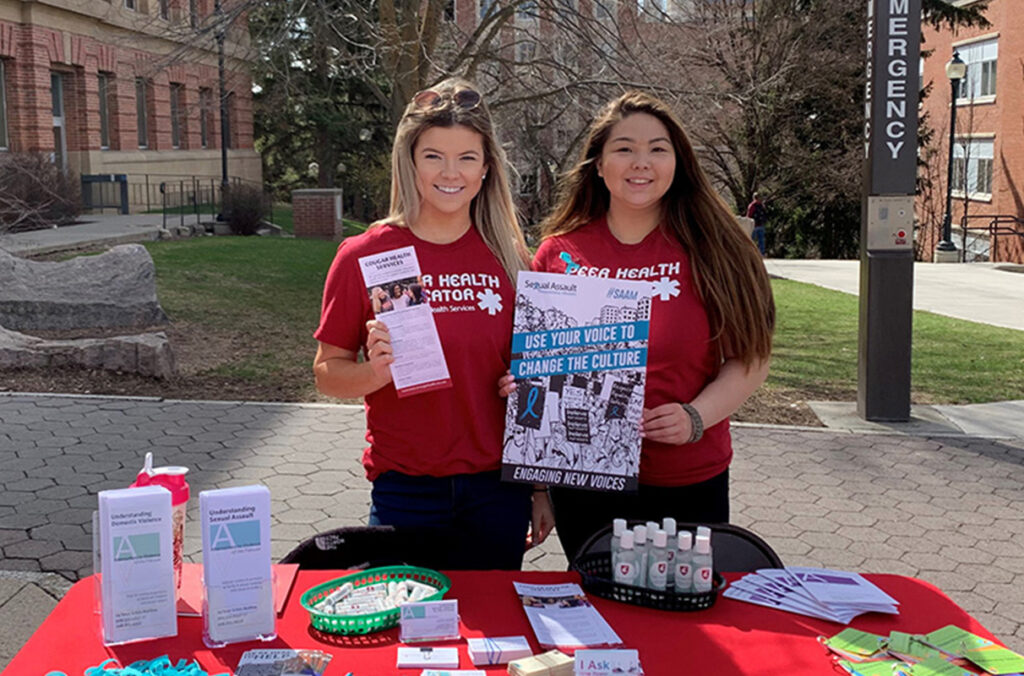 Peer Health Educators hand out information on the Pullman campus.