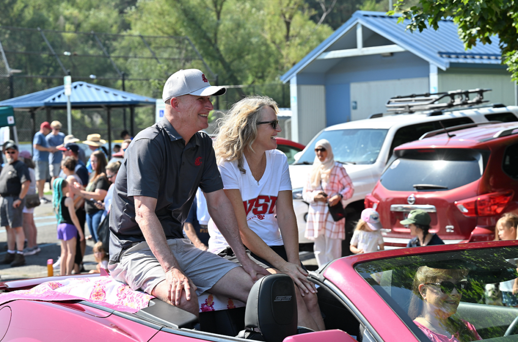Dave Cillay sitting in the back of a convertible as it drives through a parade.