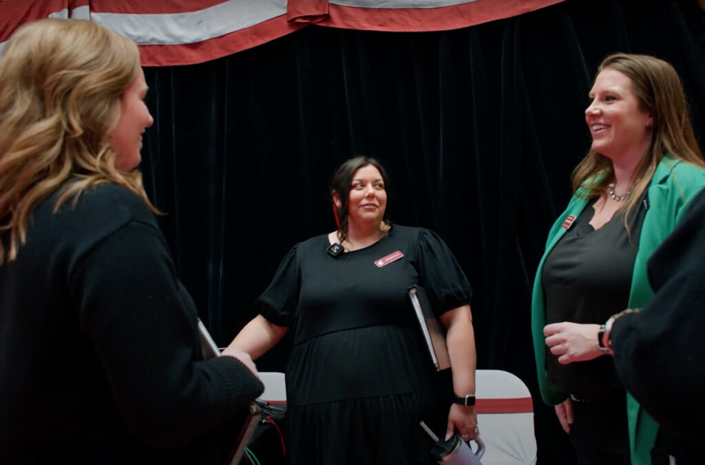 Three members of the WSU Pullman Events team smiling as they prepare for commencement.