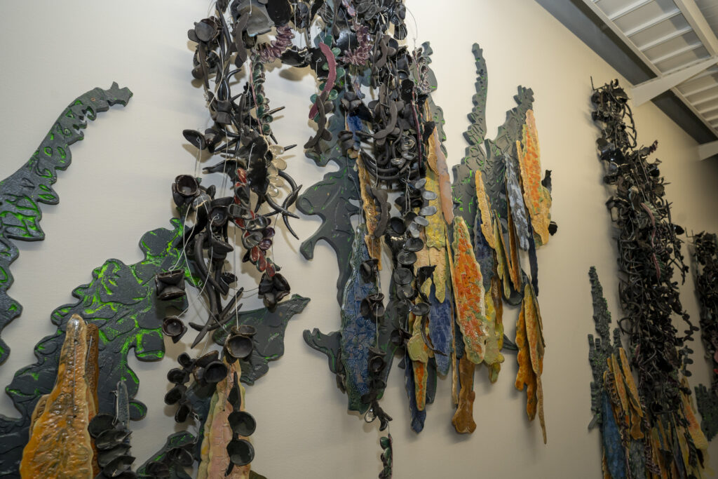 Close detail of the mixed-media mural "Foxgloves and Swarms" by Io Palmer.