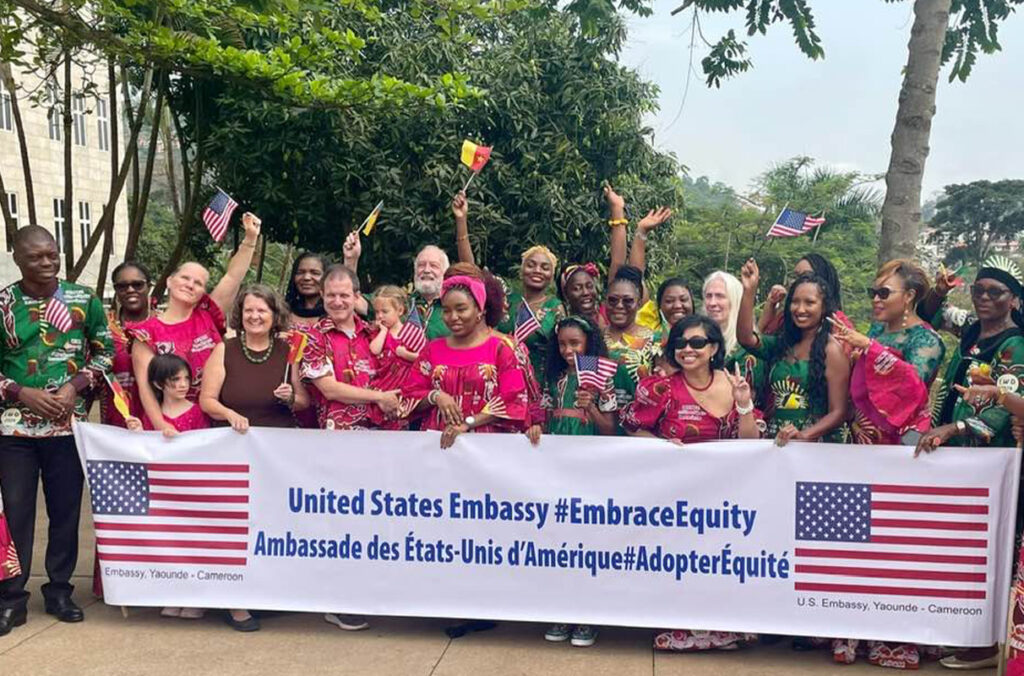 Luna Magpili and others from the U.S. Embassy holding a banner in support of International Women's Day.