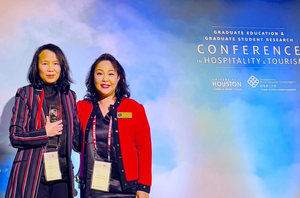 WSU Professor Christina Chi, left, accepts the Michael D. Olsen Research Achievement Award from Associate Professor Joanne Yoo, University of Delaware.