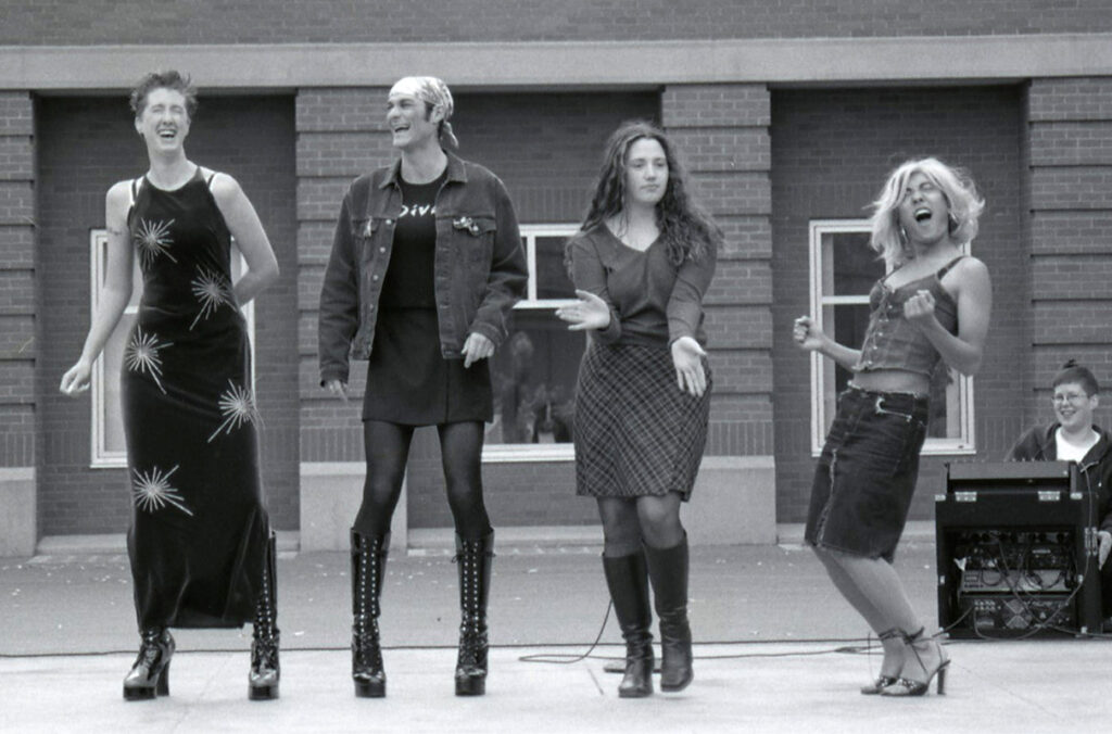 A black and white image of four people participating in a drag show on the WSU Pullman campus.